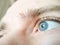 Selective focus eye of caucasian man. Macroshot texture of male skin surface, retina, eyelashes, eyebrows. Ð¡oncept of importance