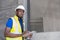 Selective focus at face of Black African foreman at building construction site, wearing protective hat and safety equipment while