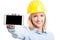 Selective focus of female engineer wearing helmet showing smartphone