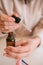 Selective focus female hands with essential oil bottle