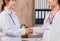 Selective focus Female medicine doctor shake hand as hello with businesswoman in office, healthcare and professionalism concept.