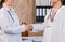 Selective focus Female medicine doctor shake hand as hello with businesswoman in office, healthcare and professionalism concept.