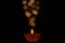 Selective focus on flame of clay diya lamp lit on dark background