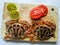 Selective focus of Fresh Crucifix Crab decorated with lemon slice and tomato slice on a wooden pad.White Background