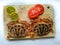 Selective focus of Fresh Crucifix Crab decorated with lemon slice and tomato slice on a wooden pad.White Background