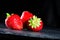selective focus on fresh strawberries on dark background, close-