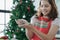 Selective focus on ginger man cookie dough in little girl`s hands. Kid girl proudly present Christmas ginger cookies she made