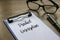 Selective focus of glasses, pen, clipboard and paper written with Product Description on wooden background