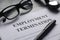 Selective focus of glasses,watch,pen and Employment Termination letter on a white wooden background