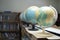 Selective focus globe model simulation with bookshelf background