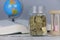 Selective focus of Gold coins, book, hourglass and globe. Finance and education concept