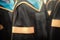 Selective focus on gowns of bachelor degree graduates in commencement graduation ceremony row, metaphor