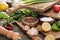 Selective focus of green onion, cutting boards, lemons, chili peppers, salt mill, salt, spices, greenery and garlics.