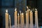 Selective focus on group of burning glowing candles light in the