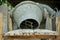 Selective focus on group of crashed stones on the steel plate with blurred concrete mixer