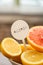 Selective focus of halves of lemons and grapefruits in white bowl