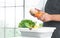 Selective focus on hands of senior man washing and rubbing corn and tomato at home. Vegetables, lettuce and lemon soak with water
