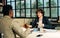 Selective focus handsome businessman seriously discussing with argument, disputing while sitting in modern meeting room at office