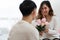Selective focus of happy Asian young woman gets bouquet of pink flowers from her boyfriend
