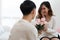 Selective focus of happy Asian young woman gets bouquet of pink flowers from her boyfriend