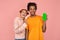Selective focus of happy ginger woman and dark skinned man points to modern device with green screen with alfa channel