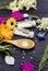 Selective focus on Homeopathic Medicine pills on spoon and medicinal bottles, decorated with fresh various herbal plants.