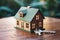 Selective focus: House model, key on wooden background, symbolic homeownership