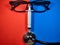 Selective focus.Human face from glasses,syringe and stethoscope on red and blue background.Medical concept.