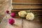 Selective focus image of dry rose, antique necklace and old vintage books on wooden table. retro filtered image