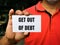 Selective focus image with noise effect hand holding white card with text GET OUT OF DEBT.
