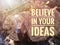 Selective focus.Inspirational motivating quotes with bulb on a wooden background.Believe in your idea.