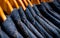 Selective focus on jacket jeans hanging on rack in clothes shop. Denim jeans with jeans pattern. Textile industry. Jeans fashion