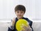 Selective focus of kid wearing disposable protective plastic glove and holding yellow balloon,Kid preparing science project about