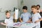 selective focus of kids drawing pictures with colorful pencils while father resting on sofa