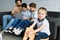 selective focus of little boy on wooden horse toy and family using laptop together on sofa