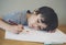 Selective focus lonely child boy lying head down on table with sad face, Emotional portrait of Five years old writing  to i love