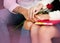 In selective focus of love couple hands,holding together,red rose in lady hand,sign and symbol of love