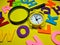 Selective focus.Magnifying glass and clock with colorful word on yellow background.