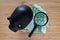 Selective focus on magnifying glass on Euro bank note with black piggy bank on wooden table as saving