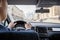 Selective focus of man hands on steering wheel driving a car on the speed highway. View from above. Moscow. Russia.