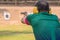 Selective focus of man holding and fire hand gun in gun shooting competition