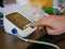 Selective focus of an old man`s hand placed next to the monitor checking his blood pressure at home by himself