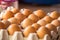 Selective focus on one of egg rows, food background, Fresh eggs in a cardboard panel