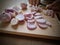 Selective focus on onions cutting with knife on wooden chopping board