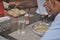 Selective focus of people eating tibetan food at indoor fast food cafe seen through window glass