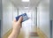 Selective focus on person hand holding blank European Health Insurance Card inside medical hospital.