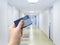 Selective focus on person hand holding blank European Health Insurance Card inside medical hospital.