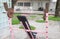 Selective focus and perspective view of old, grunge and rusty barbell equipment in the public outdoor gym which is free of charge