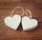 Selective focus photo of couple of wooden hearts on rustic table. valentine\'s day celebration concept.