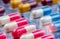 Selective focus on pink-white antibiotic capsule pills in blister pack. Pharmaceutical industry. Antibiotic drug resistance